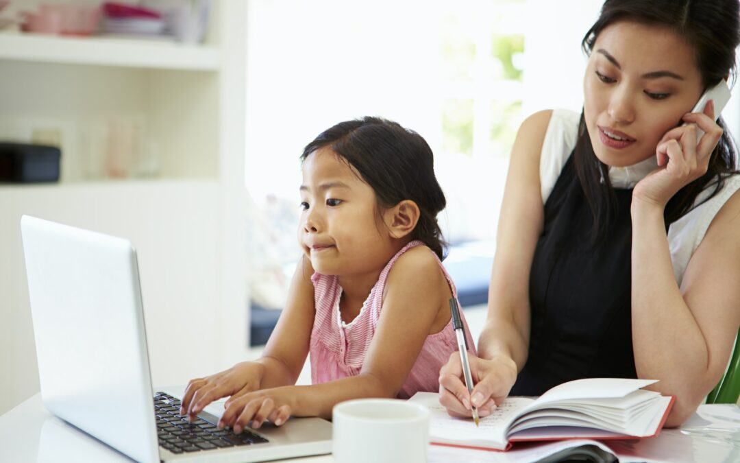 Busy Mother Working From Home With Daughter