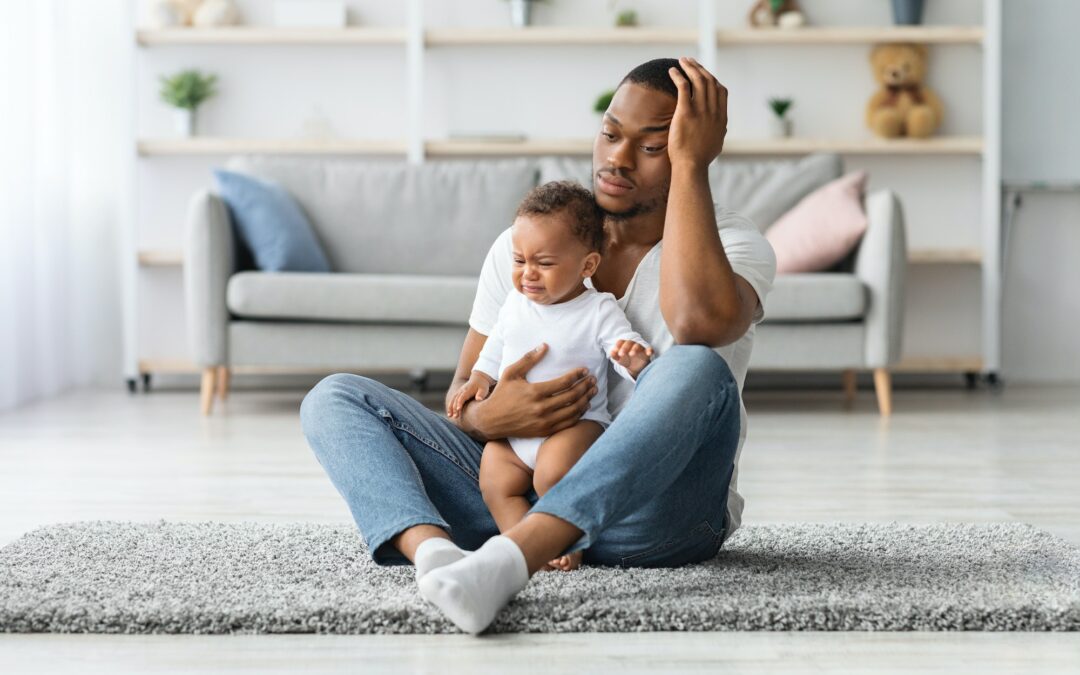 Daddy Blues. Stressed Young Black Father Sitting With Crying Infant Baby