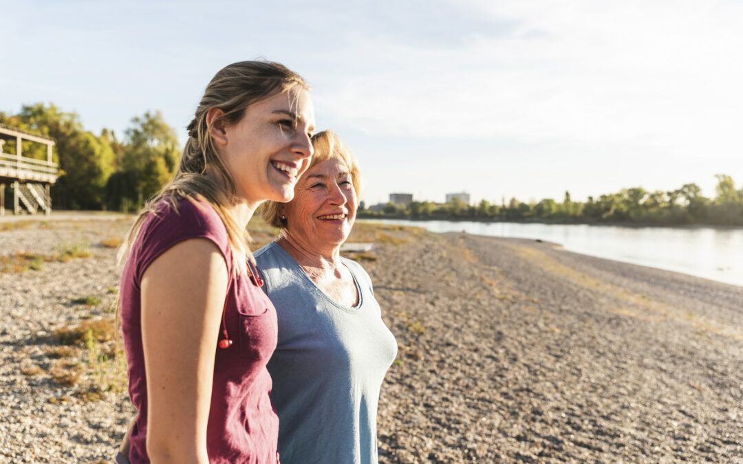 Fit grandmother and grandmother enjoying the sun at the river